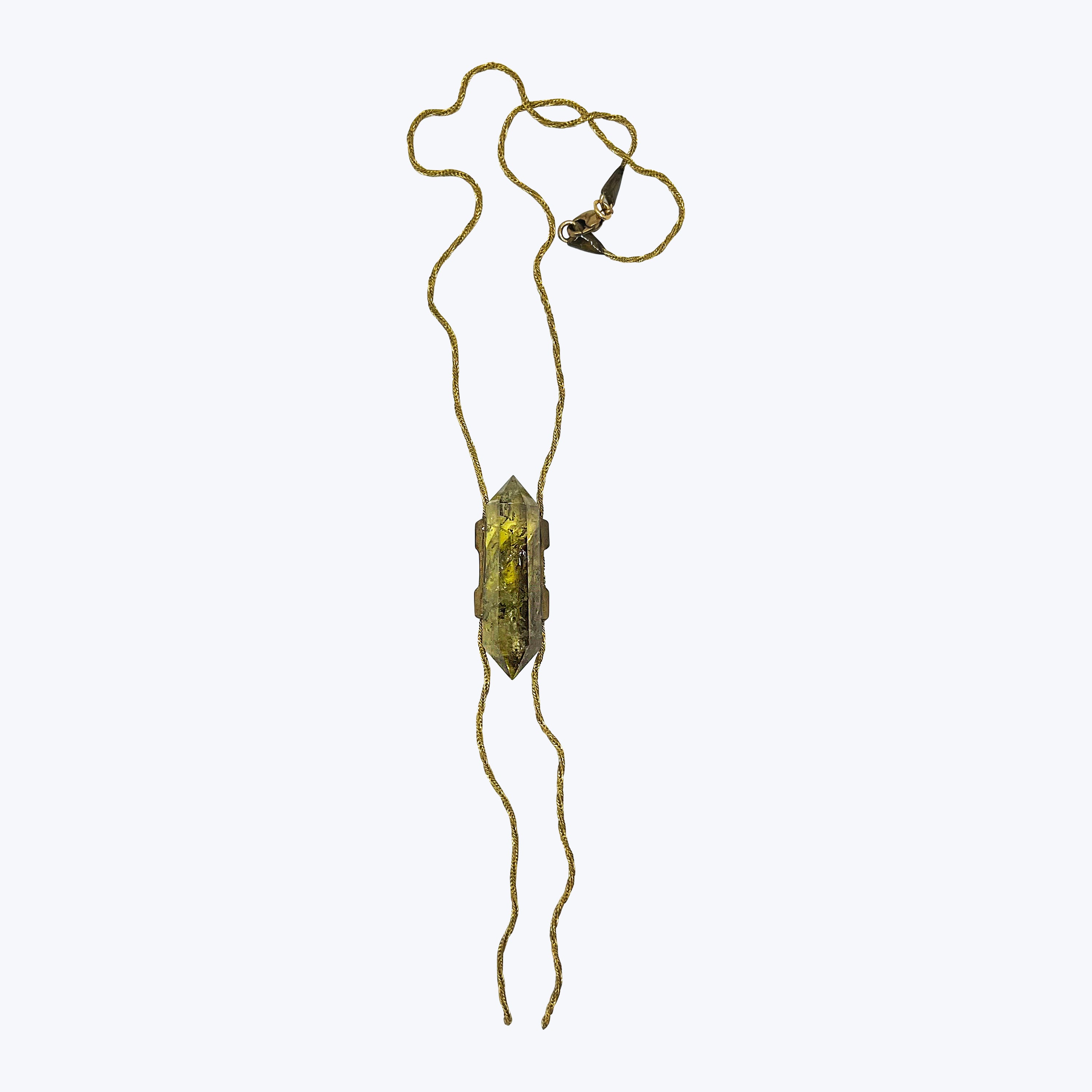 Yellowish green crystal pendant on twisted chain, modern jewelry design.