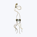 Luxurious gold earring with dark gemstone and swaying chains.