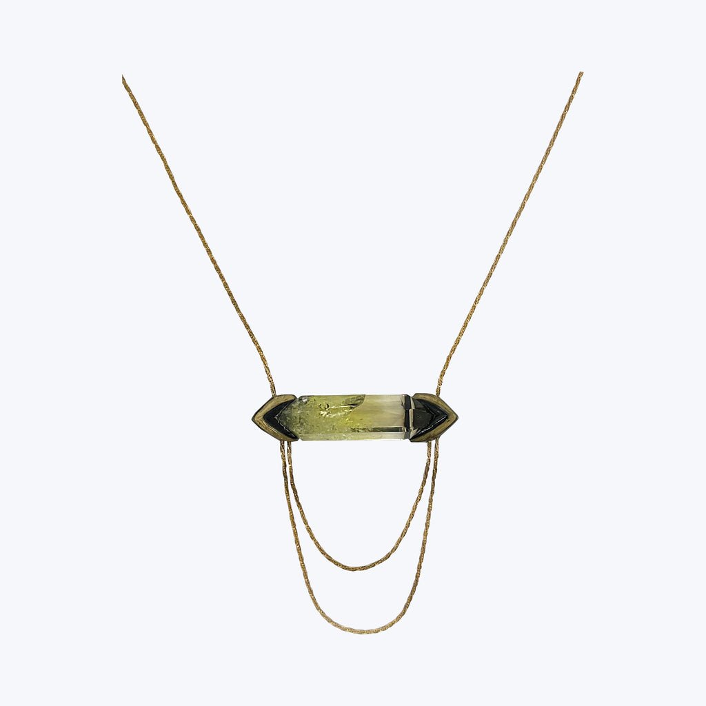 Elegant minimalist necklace with large transparent gemstone in dark setting.