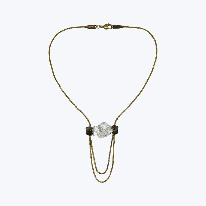 Gold-tone lariat necklace with transparent stones and black beads.