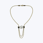 Gold-tone lariat necklace with transparent stones and black beads.