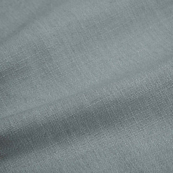 Close-up view of grey textured fabric with fine woven pattern.