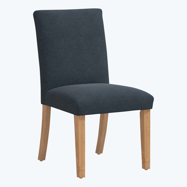 Modern dining chair with tall back, grey upholstery and wooden legs.