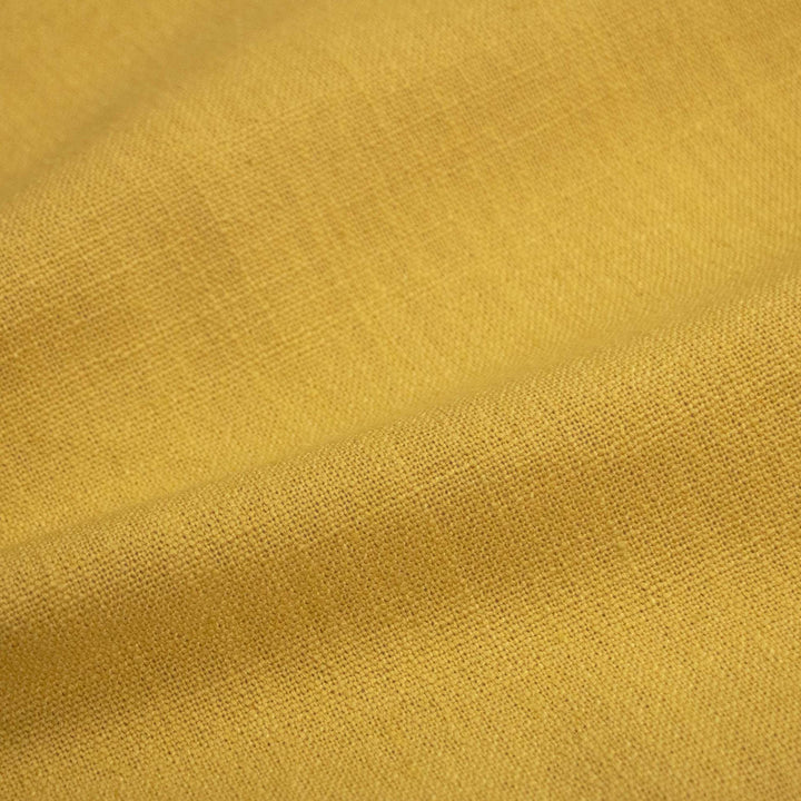 Close-up of durable golden-yellow textured fabric with visible weave pattern.