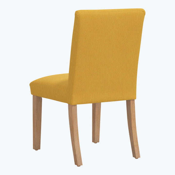 Modern dining chair with mustard upholstery, light wood legs design.