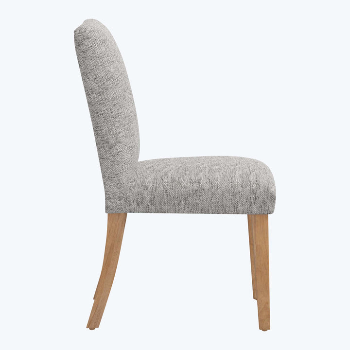 Modern dining chair with curved high backrest, cushioned seat, light wood.
