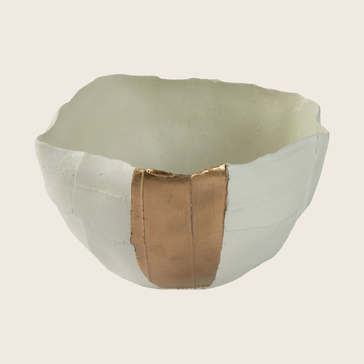Broken bowl repaired with golden Kintsugi technique, showcasing history beautifully.