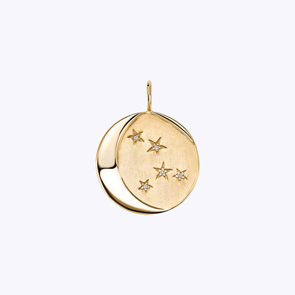 Elegant gold pendant with celestial design and sparkling gemstones.