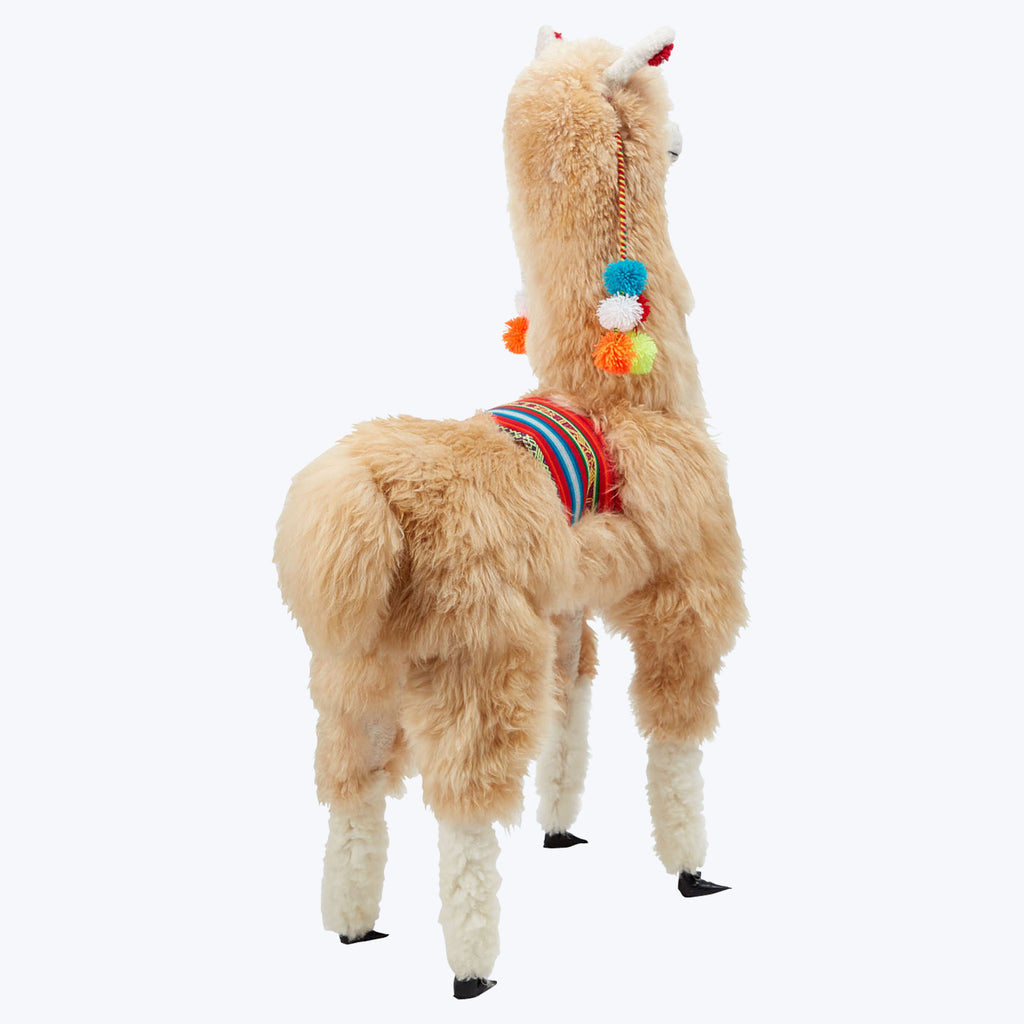 Adorable llama plush toy with colorful decorations on white background.