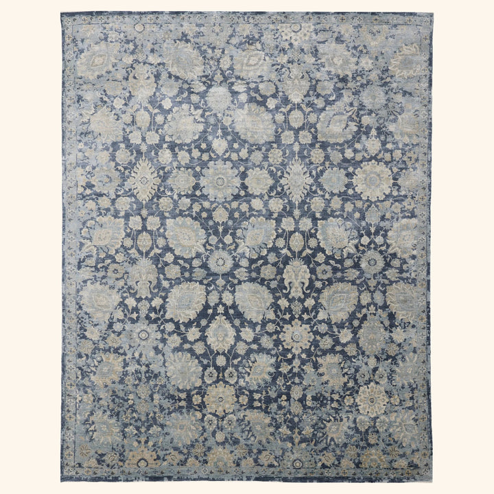 Intricate floral patterned rectangular area rug in muted colors.