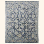 Intricate floral patterned rectangular area rug in muted colors.