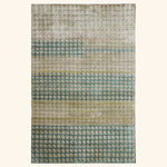 Handwoven rug with teal gradient and repeating pattern design detail.