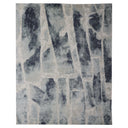 Abstract-style rug with grey and blue distressed painterly pattern.