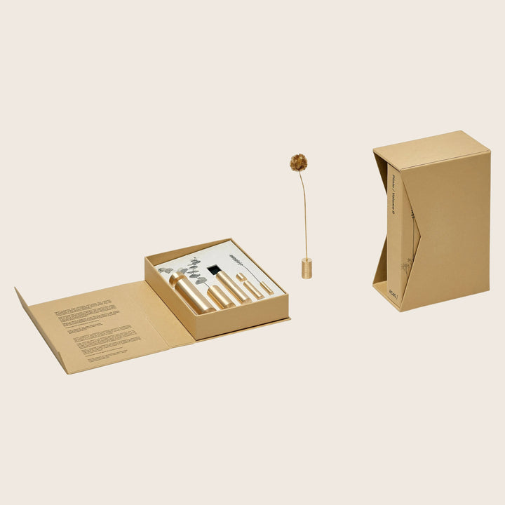 Eco-friendly skincare set packaging with minimalist design and dried flower.