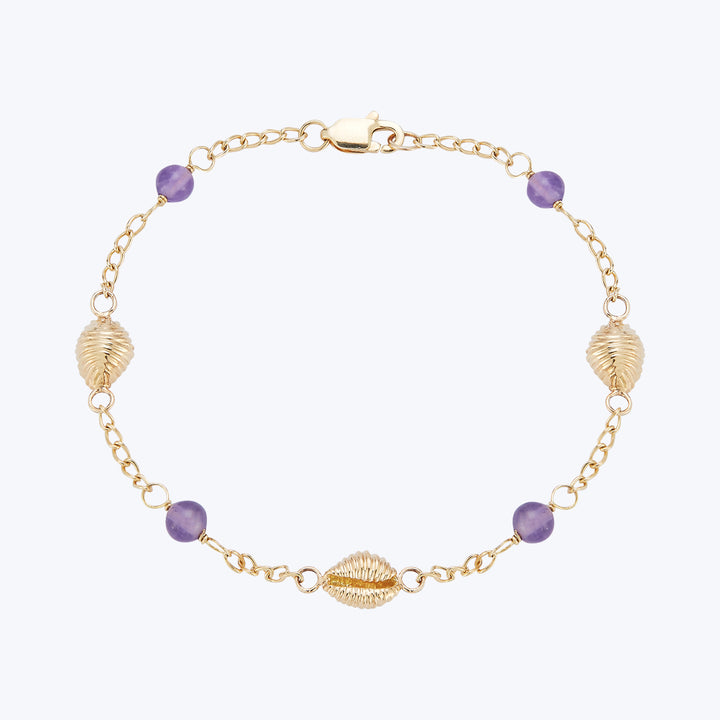 Delicate gold bracelet with shell charms, purple gems, and clasp.