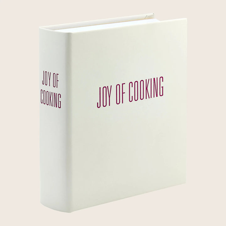 Thick cookbook with plain cover reading 'JOY OF COOKING'