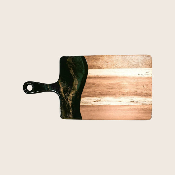 Rectangular wooden cutting board with handle and burnt stain design.