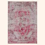 Vintage distressed pink and grey area rug with floral medallion.