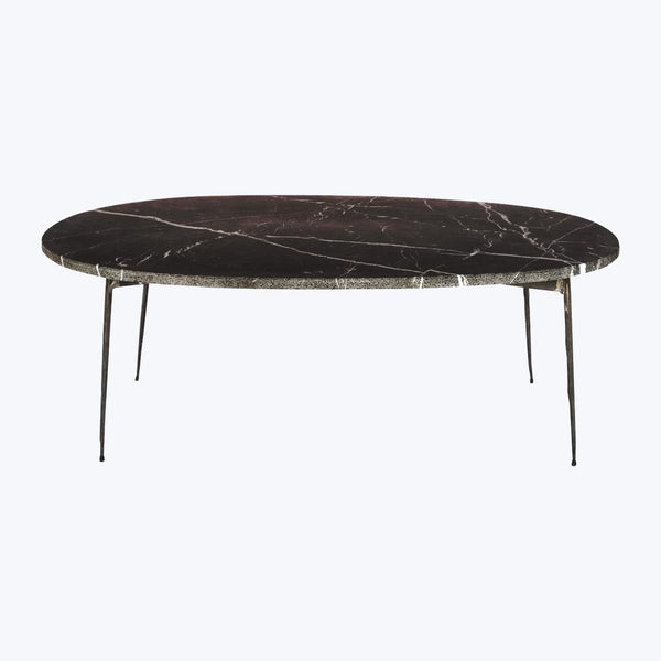 Elegant elliptical table with marble-like top and minimalist metal legs.