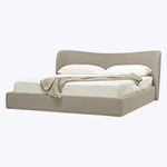 Modern upholstered bed in light beige with elegant curved headboard.