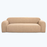 Modern, neutral-toned couch with contoured shape and textured upholstery fabric.