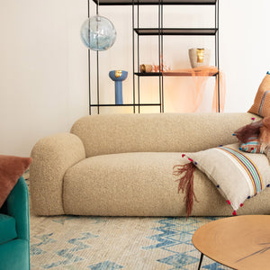 Modern, neutral-toned couch with contoured shape and textured upholstery fabric. - hover