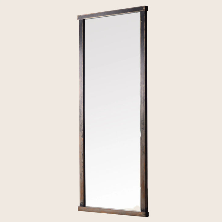 Vertical full-length mirror with rustic metal frame against white background.