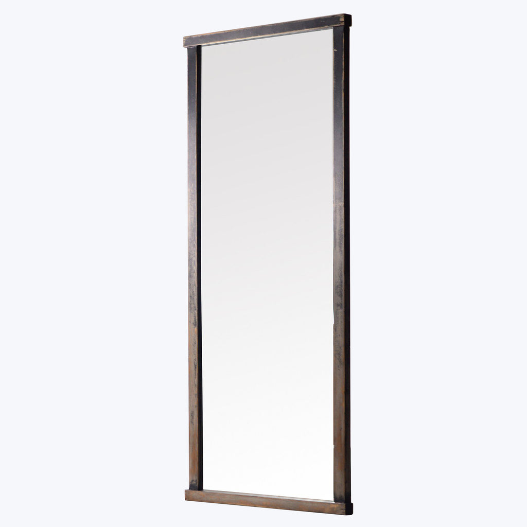 Vertical full-length mirror with rustic metal frame against white background.