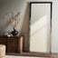 Contemporary room with dark mirror, console table, and rustic decor.