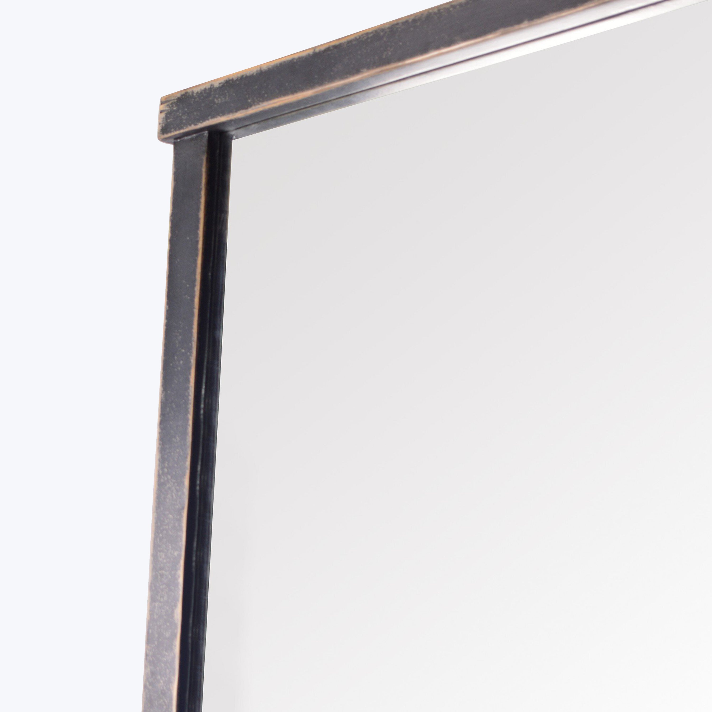 Metal frame on white surface, showing signs of wear.