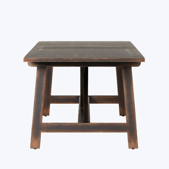 Dark stained wooden table with rustic design on white background.