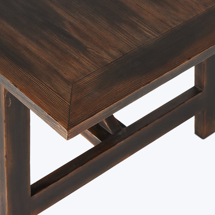 Modern, minimalist dark brown wooden table with visible wood grain.