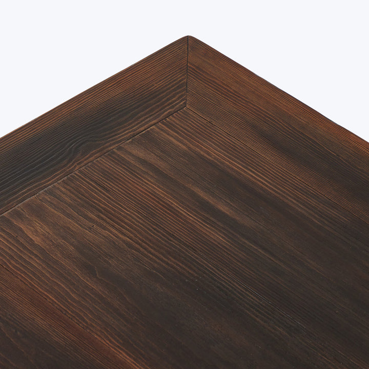 Close-up of rich brown textured wood grain on furniture corner.