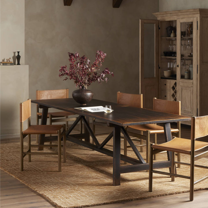 Modern dining room with dark wood table, leather chairs, rustic decor.