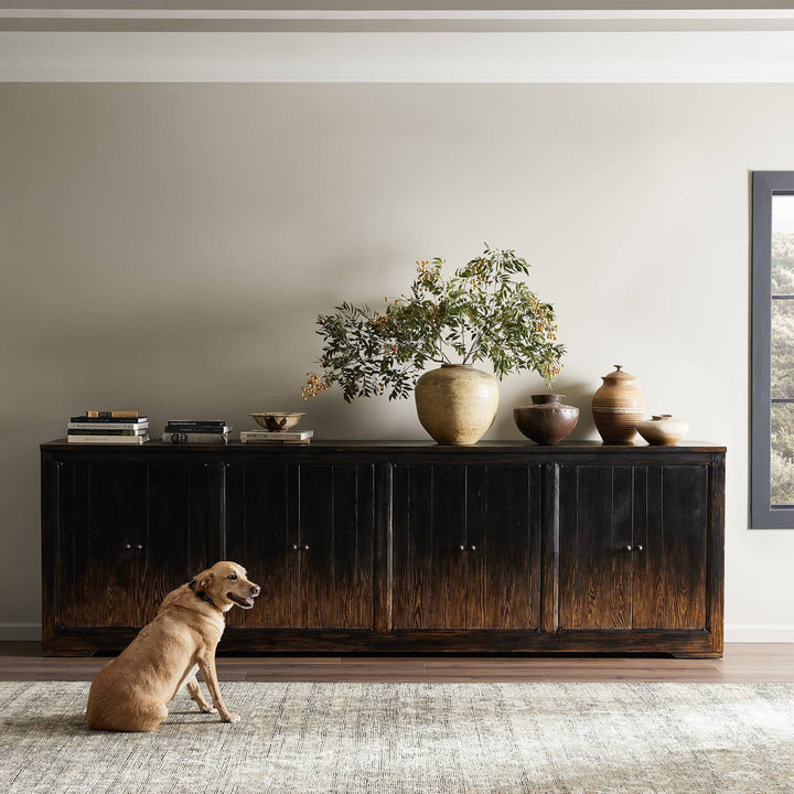 Tranquil interior space with wooden sideboard, dog, and elegant decor