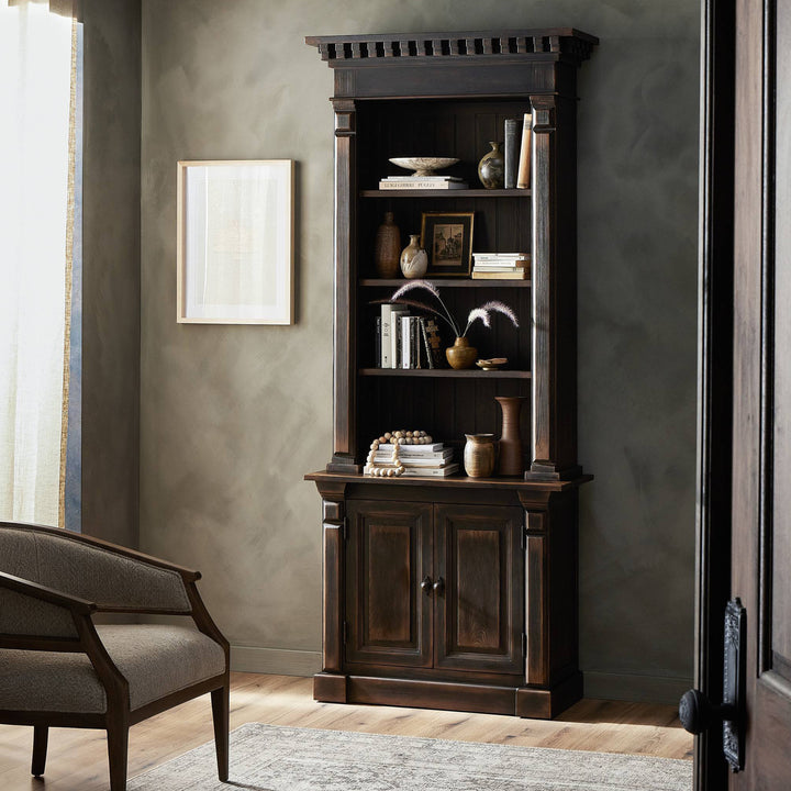 Classic dark wood bookcase with books, decor, and elegant design