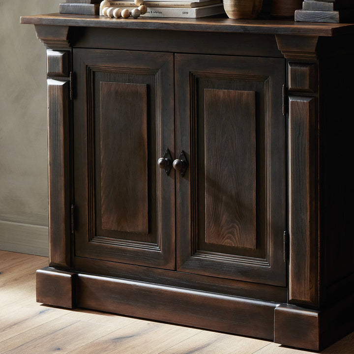Elegant wooden cabinet with classic design and decorative accessories displayed.