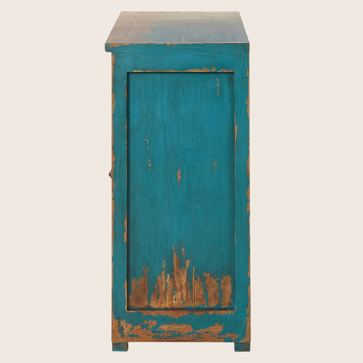 Distressed turquoise wooden cabinet with chipped paint for rustic charm