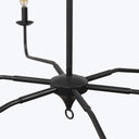 Close-up of black metal chandelier with bulb holder and loop.