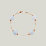 Elegant pale blue bead bracelet with glittery accents, rose gold.