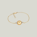 Elegant gold bracelet with gemstone accents on white background display.