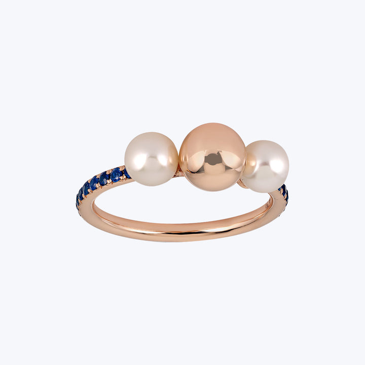Elegant rose gold ring with pearl-like ornaments and sapphire accents