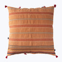 Decorative pillow with textured fabric, tassels in earthy tones design.