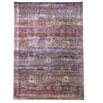 Vintage distressed ornate rug with intricate Persian-inspired design in rich colors.