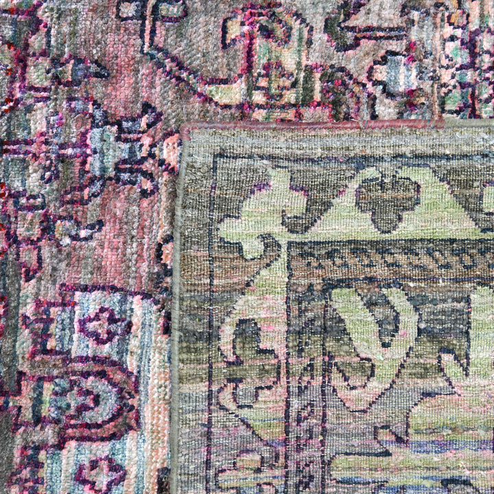 Close-up of aged, intricate woven fabric with faded colors.