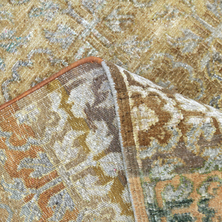 Close-up of ornately patterned rug with various colors and wear.