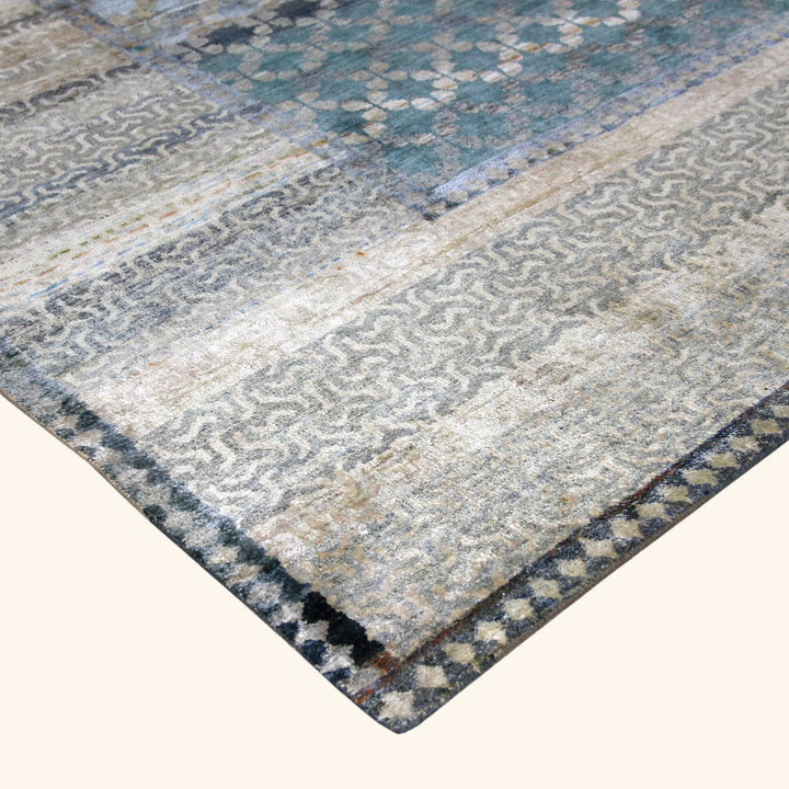 Modern rug with abstract geometric pattern in shades of blue.