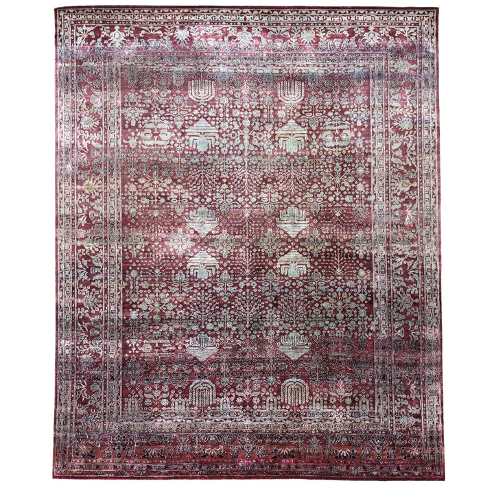 Intricate red-hued carpet with floral and geometric motifs displayed flat.