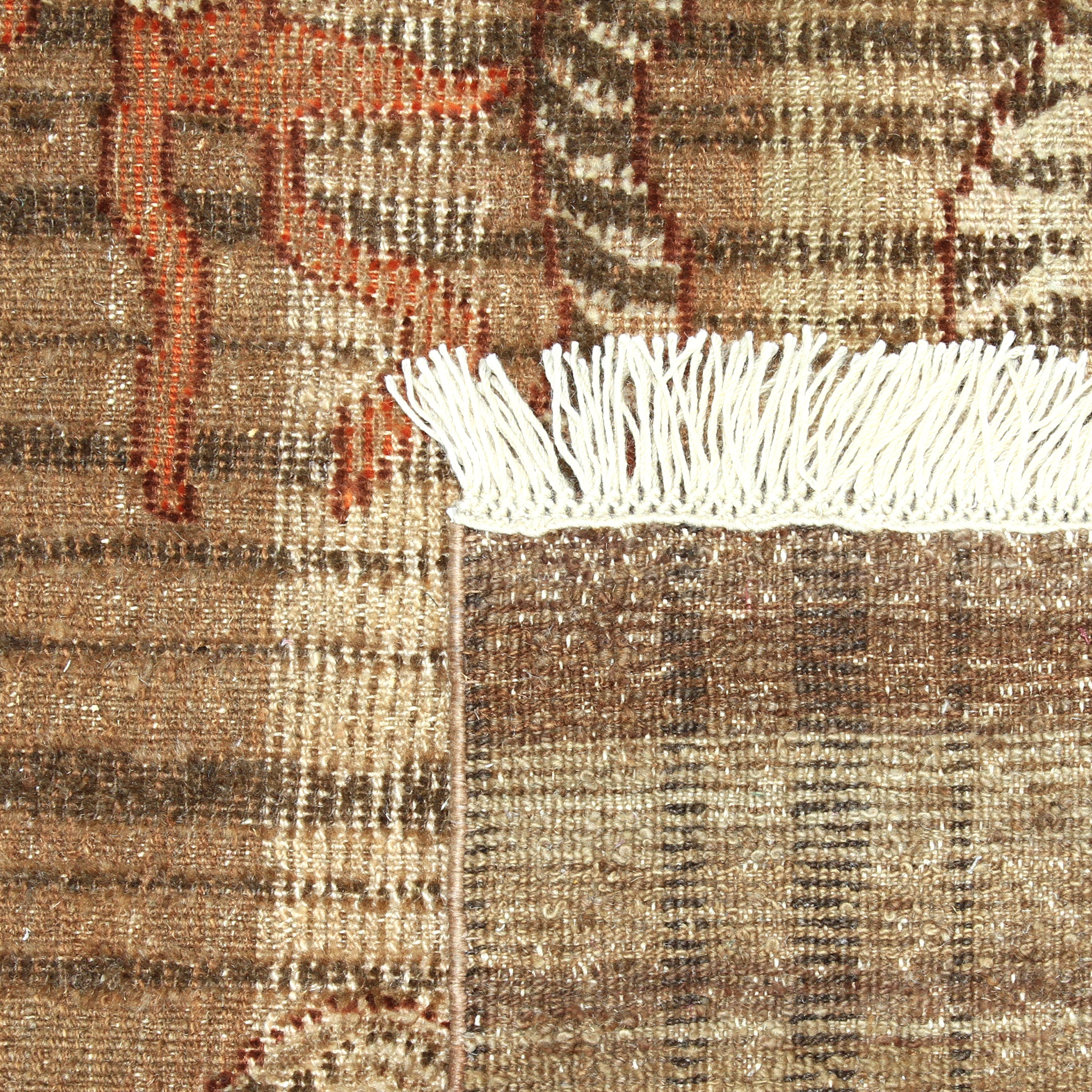 Intricate brown tapestry with red and beige details and fringe.