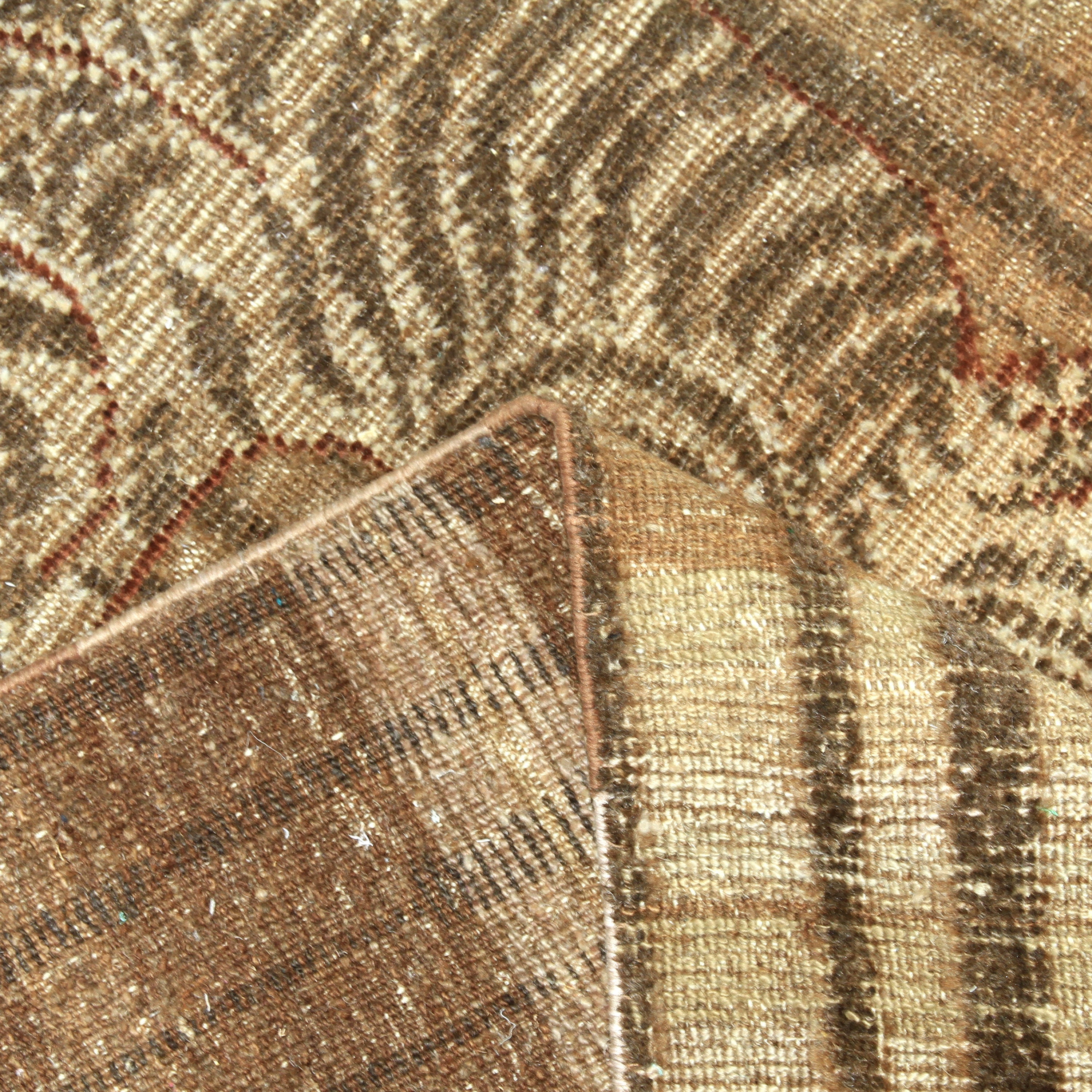 Close-up of textured fabric with geometric design in earth tones.